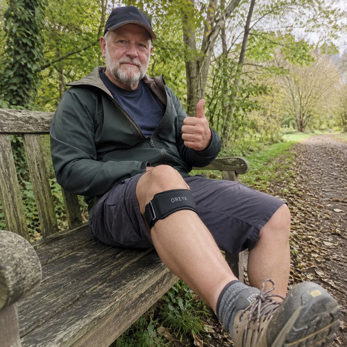 Man wearing OREYA Precision Knee Support Strap during a walk