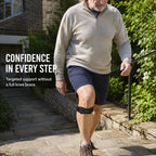 Man walking up steps wearing OREYA Precision Knee Support Strap